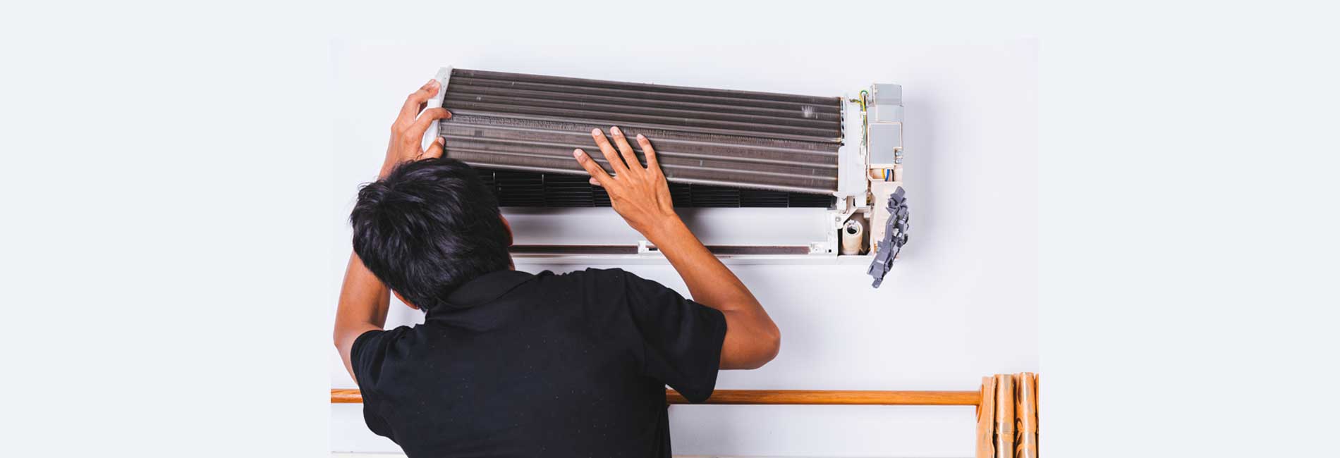 AC repair technician servicing air conditioner